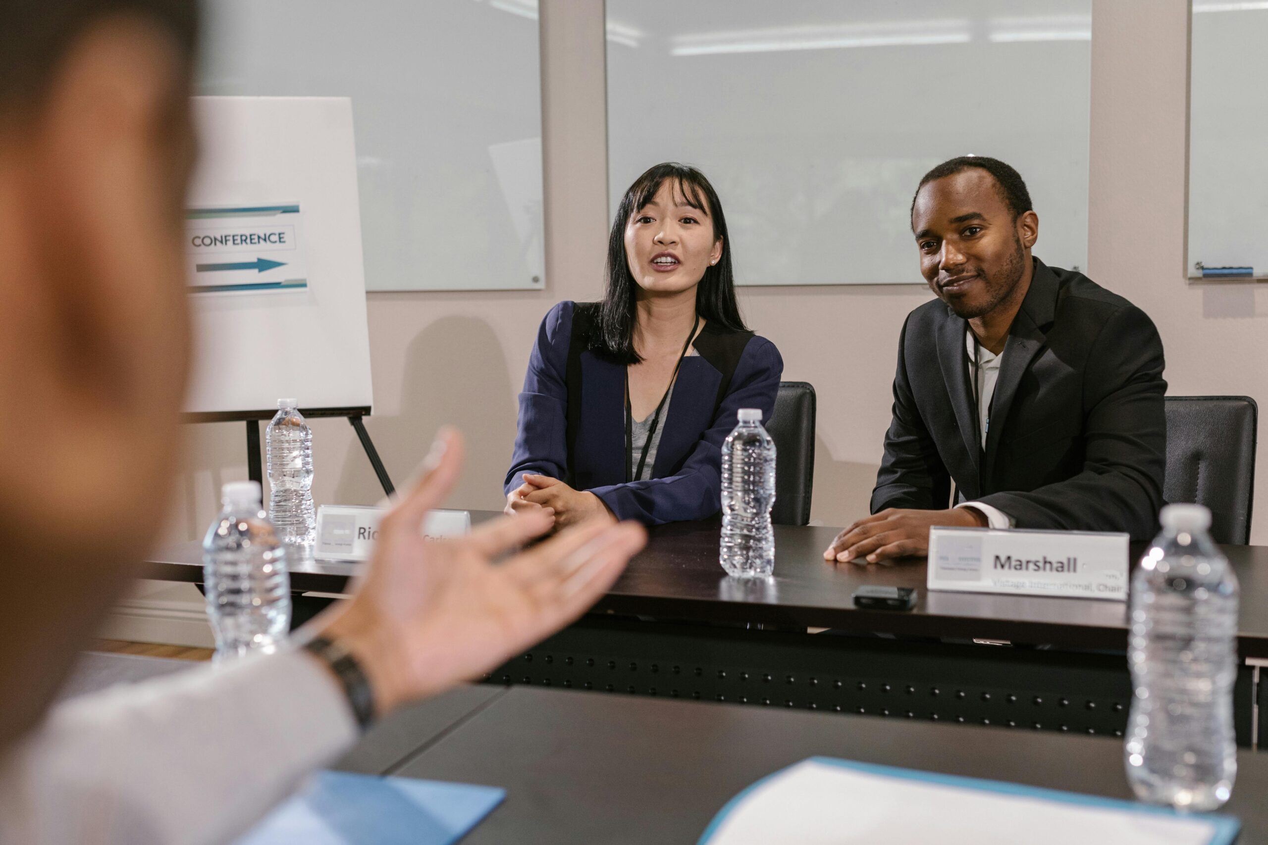 Professional business team engaged in a corporate meeting. They discuss strategies at a conference.